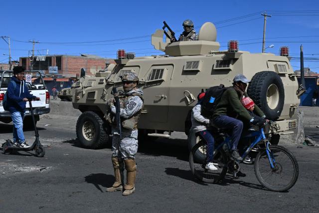 Military police and soldiers are deployed at a blockade zone in Cruce Ventilla in El Alto, Bolivia on June 20, 2026, after Bolivian president Rodrigo Paz declared state of emergency. Bolivian President Rodrigo Paz declared a state of emergency across the Latin American country after more than six weeks of road blockades and protests demanding his resignation, saying he had exhausted "all avenues of dialogue." (Photo by AIZAR RALDES / AFP)