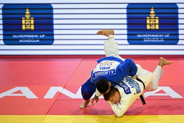 Ankhzaya Lavjargal (top) of Mongolia and Jack Yonezuka of USA compete during the men's under 73kg final event at the Judo Ulaanbaatar Grand Slam 2026 in Ulaanbaatar, Mongolia on June 20, 2026. (Photo by ADEK BERRY / AFP)