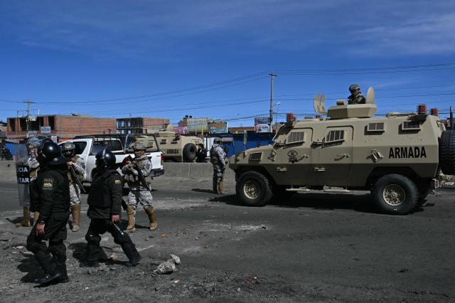 Military police and soldiers are deployed at a blockade zone in Cruce Ventilla in El Alto, Bolivia on June 20, 2026, after Bolivian president Rodrigo Paz declared state of emergency. Bolivian President Rodrigo Paz declared a state of emergency across the Latin American country after more than six weeks of road blockades and protests demanding his resignation, saying he had exhausted "all avenues of dialogue." (Photo by AIZAR RALDES / AFP)