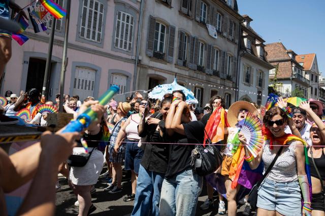 People are sprayed with water as they take part in the annual Gay Pride parade, known in French as « La Marche des Fiertés LGBT+ », in Strasbourg, eastern France on June 20, 2026. (Photo by ROMEO BOETZLE / AFP)