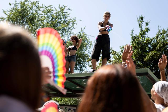 A person sprays attendees with a water gun as they take part in the annual Gay Pride parade, known in French as « La Marche des Fiertés LGBT+ », in Strasbourg, eastern France on June 20, 2026. (Photo by ROMEO BOETZLE / AFP)