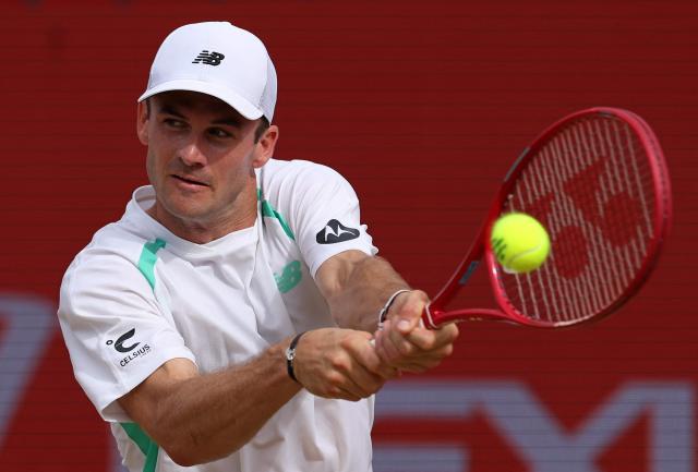 US player Tommy Paul returns to France's Ugo Humbert during their men's singles semi-final tennis match on day six of the ATP HSBC Championships at Queen's Club in west London on June 20, 2026. (Photo by Adrian Dennis / AFP)