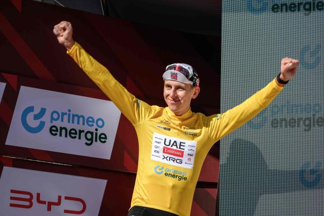 UAE Team Emirates-XRG's Slovenian rider Tadej Pogacar wearing the overall leader's yellow jersey celebrates on the podium of the fourth stage, a 23.7 km time trial from Aarburg to Aarburg, at the Men's Tour of Switzerland (Tour de Suisse) cycling race in Aarburg, Switzerland, on June 20, 2026. (Photo by Fabrice COFFRINI / AFP)