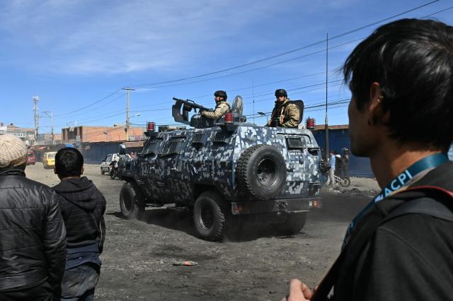 Military police are deployed at a blockade zone in Cruce Ventilla in El Alto, Bolivia on June 20, 2026, after Bolivian President Rodrigo Paz declared state of emergency. Bolivian President Rodrigo Paz declared a state of emergency across the Latin American country after more than six weeks of road blockades and protests demanding his resignation, saying he had exhausted "all avenues of dialogue." (Photo by AIZAR RALDES / AFP)