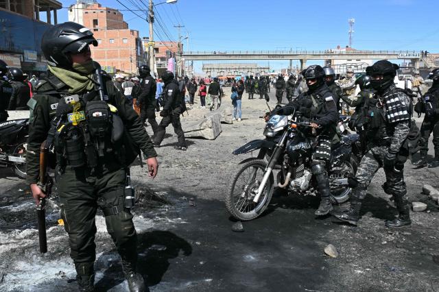 Police officers on motorcycles are deployed at a blockade zone in Cruce Ventilla in El Alto, Bolivia on June 20, 2026, after Bolivian President Rodrigo Paz declared state of emergency. Bolivian President Rodrigo Paz declared a state of emergency across the Latin American country after more than six weeks of road blockades and protests demanding his resignation, saying he had exhausted "all avenues of dialogue." (Photo by AIZAR RALDES / AFP)