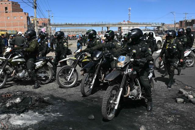 Police officers on motorcycles are deployed at a blockade zone in Cruce Ventilla in El Alto, Bolivia on June 20, 2026, after Bolivian President Rodrigo Paz declared state of emergency. Bolivian President Rodrigo Paz declared a state of emergency across the Latin American country after more than six weeks of road blockades and protests demanding his resignation, saying he had exhausted "all avenues of dialogue." (Photo by AIZAR RALDES / AFP)