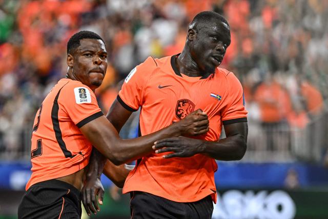 CORRECTION / Netherlands' forward #19 Brian Brobbey (R) celebrates with Netherlands' defender #22 Denzel Dumfries after scoring his team's second goalduring the 2026 World Cup Group F football match between the Netherlands and Sweden at the Houston Stadium in Houston on June 20, 2026.  (Photo by Paul ELLIS / AFP) / The erroneous mention[s] appearing in the metadata of this photo by Paul ELLIS has been modified in AFP systems in the following manner: [Netherlands' forward #19 Brian Brobbey (R) celebrates with Netherlands' defender #22 Denzel Dumfries after scoring his team's second] instead of [Netherlands supporters make their way to the venue to attend a the ]. Please immediately remove the erroneous mention from all your online services and delete it  from your servers. If you have been authorized by AFP to distribute it to third parties, please ensure that the same actions are carried out by them. Failure to promptly comply with these instructions will entail liability on your part for any continued or post notification usage. Therefore we thank you very much for all your attention and prompt action. We are sorry for the inconvenience this notification may cause and remain at your disposal for any further information you may require.