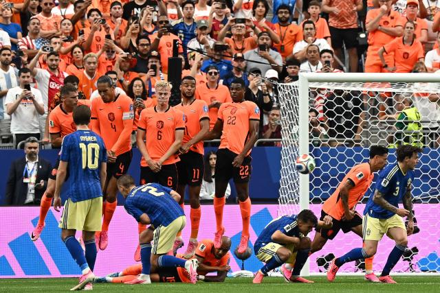 Netherlands' players jump to block a free kick  during the 2026 World Cup Group F football match between the Netherlands and Sweden at the Houston Stadium in Houston on June 20, 2026.  (Photo by Paul ELLIS / AFP)