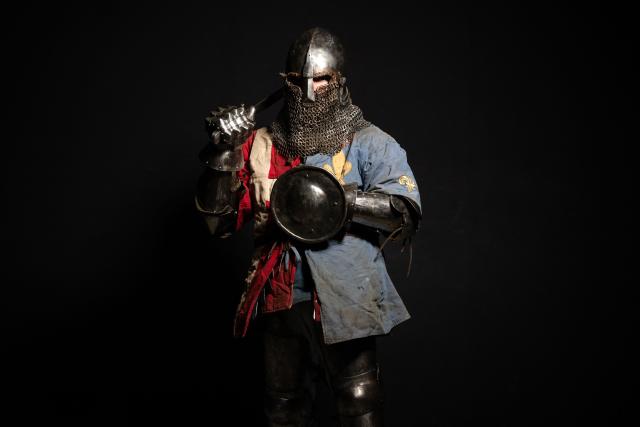 A competitor poses in his combat gear as part of the Knights of the Cage, a gala of the medieval armored combat or buhurt, in Onet-le-Chateau, southwestern France, on June 20, 2026. Fighters in armor with shields and swords, or axes, have taken part in about twenty fights in an MMA cage in Aveyron. It was overwhelmingly men who fought in individual "behourd profight" clashes, presented as the modern version of "what was the equivalent of MMA of the Middle Ages" by the town hall of Onet-le-Chateau. French, Polish, and British fighters participated in this event at the Salle d'Armes Ecole Ancienne (SAEA), a club specializing in buhurt.
"The word 'buhurt' comes from Old French; it was a recreational activity for men in the Middle Ages... It's the intersection of history and combat sports," explains Clement Carsac, president of SAEA Aveyron. 
Before the fights, participants must be weighed because, as in boxing, there are weight categories in buhurt profight. They then put on their armor and helmets, which can weigh up to six kilos. The outfit is rather expensive: "A complete set costs between 3,000 and 4,000 euros," according to Clement Carsac. (Photo by Valentine CHAPUIS / AFP)