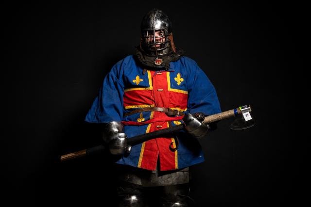 A competitor poses in his combat gear as part of the Knights of the Cage, a gala of the medieval armored combat or buhurt, in Onet-le-Chateau, southwestern France, on June 20, 2026. Fighters in armor with shields and swords, or axes, have taken part in about twenty fights in an MMA cage in Aveyron. It was overwhelmingly men who fought in individual "behourd profight" clashes, presented as the modern version of "what was the equivalent of MMA of the Middle Ages" by the town hall of Onet-le-Chateau. French, Polish, and British fighters participated in this event at the Salle d'Armes Ecole Ancienne (SAEA), a club specializing in buhurt.
"The word 'buhurt' comes from Old French; it was a recreational activity for men in the Middle Ages... It's the intersection of history and combat sports," explains Clement Carsac, president of SAEA Aveyron. 
Before the fights, participants must be weighed because, as in boxing, there are weight categories in buhurt profight. They then put on their armor and helmets, which can weigh up to six kilos. The outfit is rather expensive: "A complete set costs between 3,000 and 4,000 euros," according to Clement Carsac. (Photo by Valentine CHAPUIS / AFP)