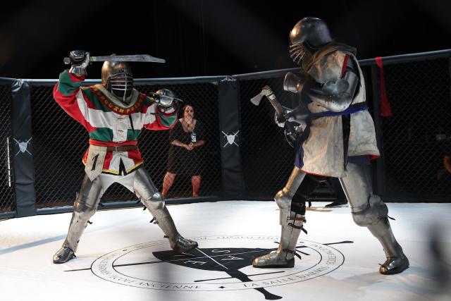 Competitors fight in an MMA (mixed martial arts) arena during the Knights of the Cage, a gala of a medieval armored combat or buhurt, in Onet-le-Chateau, southwestern France, on June 20, 2026. Fighters in armor with shields and swords, or axes, have taken part in about twenty fights in an MMA cage in Aveyron. It was overwhelmingly men who fought in individual "behourd profight" clashes, presented as the modern version of "what was the equivalent of MMA of the Middle Ages" by the town hall of Onet-le-Chateau. French, Polish, and British fighters participated in this event at the Salle d'Armes Ecole Ancienne (SAEA), a club specializing in buhurt.
"The word 'buhurt' comes from Old French; it was a recreational activity for men in the Middle Ages... It's the intersection of history and combat sports," explains Clement Carsac, president of SAEA Aveyron. 
Before the fights, participants must be weighed because, as in boxing, there are weight categories in buhurt profight. They then put on their armor and helmets, which can weigh up to six kilos. The outfit is rather expensive: "A complete set costs between 3,000 and 4,000 euros," according to Clement Carsac. (Photo by Valentine CHAPUIS / AFP)