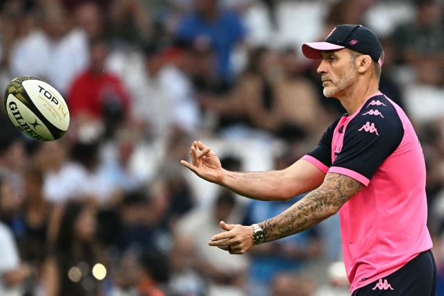 Stade Français' English head coach Paul Gustard passes the ball during the warm up ahead of the French Top14 rugby union semi-final match between Montpellier Hérault Rugby and Stade Français at the Velodrome stadium in Marseille, southern France, on June 20, 2026. (Photo by Gabriel BOUYS / AFP)