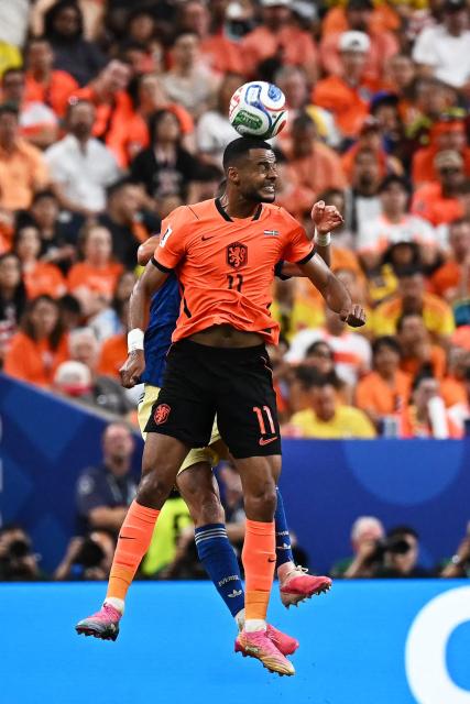 Netherlands' forward #11 Cody Gakpo jumps for the ball   during the 2026 World Cup Group F football match between the Netherlands and Sweden at the Houston Stadium in Houston on June 20, 2026.  (Photo by Paul ELLIS / AFP)
