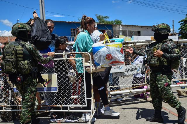 Colombian soldiers check people crossing the Simon Bolivar International Bridge linking Colombia and Venezuela, in Villa del Rosario, North Santander department, Colombia, on June 20, 2026, on the eve of the presidential election runoff. Colombians vote on June 21, 2026 in a presidential runoff pitting a hard-right opera-singer-turned-lawyer against a leftist senator, an election with stark consequences for the country's stumbling peace process with armed groups and strained ties with Washington. (Photo by Schneyder Mendoza / AFP)