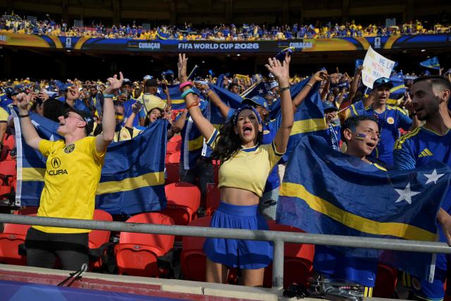 Curacao fans cheer for their team ahead of the 2026 World Cup Group E football match between Ecuador and Curacao at the Kansas City Stadium in Kansas City on June 20, 2026.  (Photo by JUAN MABROMATA / AFP)