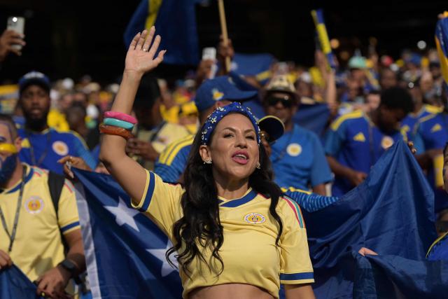 A Curacao fan cheers for her team ahead of the 2026 World Cup Group E football match between Ecuador and Curacao at the Kansas City Stadium in Kansas City on June 20, 2026.  (Photo by JUAN MABROMATA / AFP)