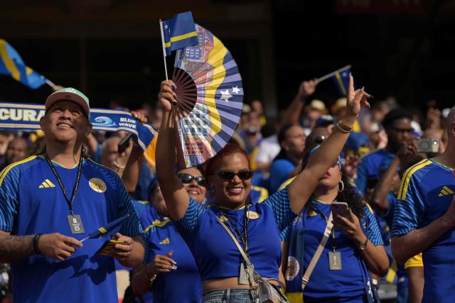 Curacao fans cheer for their team ahead of the 2026 World Cup Group E football match between Ecuador and Curacao at the Kansas City Stadium in Kansas City on June 20, 2026.  (Photo by JUAN MABROMATA / AFP)