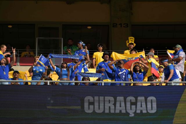 Curacao fans cheer for their team ahead of the 2026 World Cup Group E football match between Ecuador and Curacao at the Kansas City Stadium in Kansas City on June 20, 2026.  (Photo by JUAN MABROMATA / AFP)