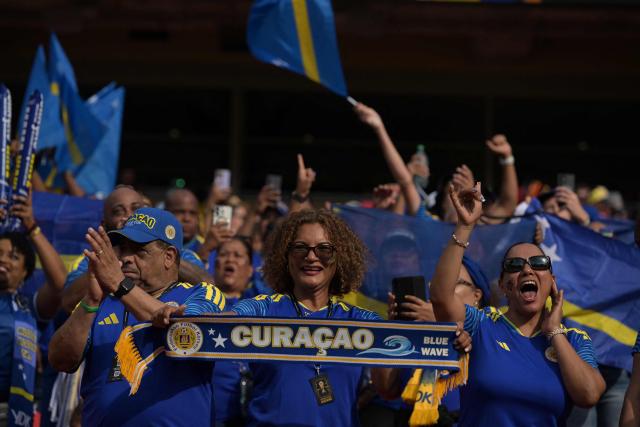 Curacao fans cheer for their team ahead of the 2026 World Cup Group E football match between Ecuador and Curacao at the Kansas City Stadium in Kansas City on June 20, 2026.  (Photo by JUAN MABROMATA / AFP)