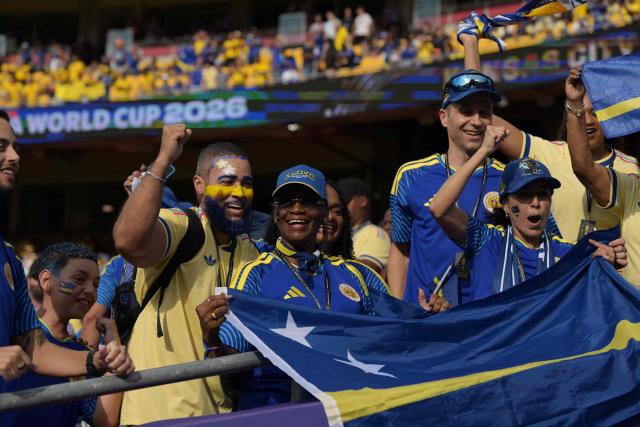 Curacao fans cheer for their team ahead of the 2026 World Cup Group E football match between Ecuador and Curacao at the Kansas City Stadium in Kansas City on June 20, 2026.  (Photo by JUAN MABROMATA / AFP)