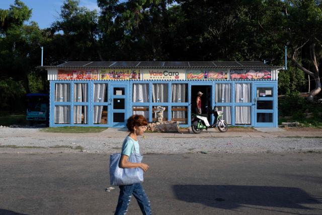 A woman walks past a private market in Alamar, eastern Havana, Cuba on June 20, 2026. (Photo by Pablo PORCIUNCULA / AFP)