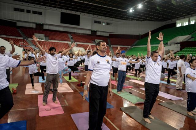 People take part in a yoga session to celebrate International Yoga Day at the Thuwanna Indoor Stadium in Yangon on June 21, 2026. (Photo by Sai Aung MAIN / AFP)