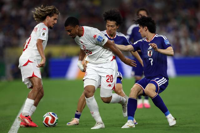 Tunisia's defender #20 Yan Valery and Japan's midfielder #07 Ao Tanaka fight for the ball during the 2026 World Cup Group F football match between Tunisia and Japan at the Monterrey Stadium in Guadalupe, Mexico, on June 20, 2026.  (Photo by Julio Cesar AGUILAR / AFP)