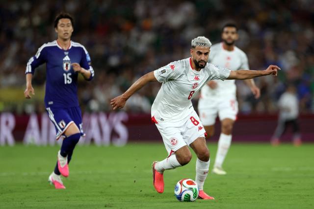 Tunisia's forward #08 Elias Saad controls the ball followed by Japan's midfielder #15 Daichi Kamada during the 2026 World Cup Group F football match between Tunisia and Japan at the Monterrey Stadium in Guadalupe, Mexico, on June 20, 2026.  (Photo by Julio Cesar AGUILAR / AFP)