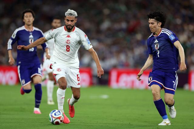 Tunisia's forward #08 Elias Saad controls the ball defended by Japan's midfielder #07 Ao Tanaka during the 2026 World Cup Group F football match between Tunisia and Japan at the Monterrey Stadium in Guadalupe, Mexico, on June 20, 2026.  (Photo by Julio Cesar AGUILAR / AFP)