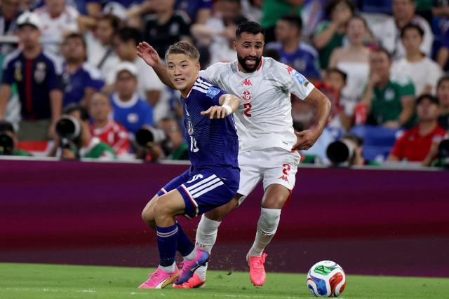 Tunisia's defender #02 Ali Abdi (R) and Japan's midfielder #10 Ritsu Doan fight for the ball during the 2026 World Cup Group F football match between Tunisia and Japan at the Monterrey Stadium in Guadalupe, Mexico, on June 20, 2026.  (Photo by Julio Cesar AGUILAR / AFP)