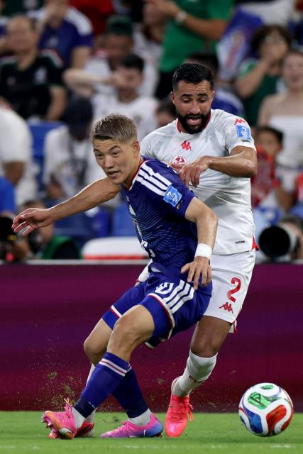 Tunisia's defender #02 Ali Abdi (R) and Japan's midfielder #10 Ritsu Doan fight for the ball during the 2026 World Cup Group F football match between Tunisia and Japan at the Monterrey Stadium in Guadalupe, Mexico, on June 20, 2026.  (Photo by Julio Cesar AGUILAR / AFP)