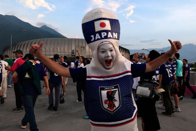 A Japanese fan, wearing a costume, cheers upon arriving to the 2026 World Cup Group F football match between Tunisia and Japan at the Monterrey Stadium in Guadalupe, Mexico, on June 20, 2026.  (Photo by Julio Cesar AGUILAR / AFP)