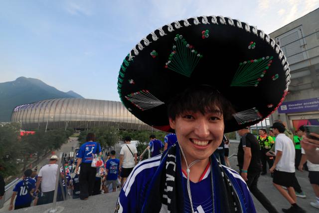 A Japanese fan, wearing a Mexican Charro sombrero, poses for a photo upon arriving to the 2026 World Cup Group F football match between Tunisia and Japan at the Monterrey Stadium in Guadalupe, Mexico, on June 20, 2026.  (Photo by Julio Cesar AGUILAR / AFP)