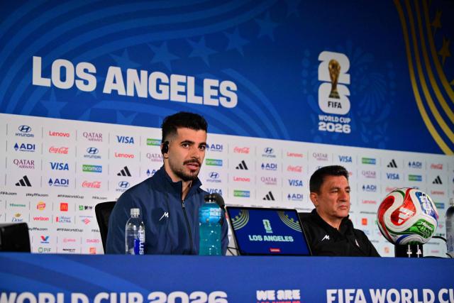 Iran's midfielder #06 Saeid Ezatolahi (L) and head coach Amir Ghalenoei (R) give an MD-1 press conference session at Los Angeles Stadium in Inglewood on June 20, 2026, on the eve of the 2026 World Cup Group G football match between Belgium and Iran. (Photo by Frederic J. Brown / AFP)