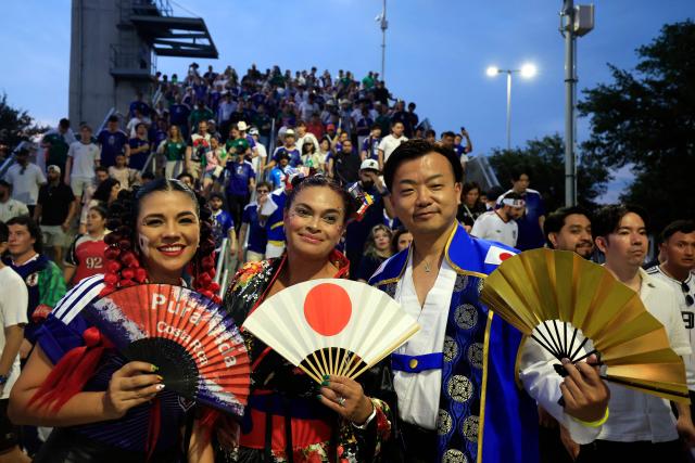 Japanese fans pose for a photo upon arriving to the 2026 World Cup Group F football match between Tunisia and Japan at the Monterrey Stadium in Guadalupe, Mexico, on June 20, 2026.  (Photo by Julio Cesar AGUILAR / AFP)