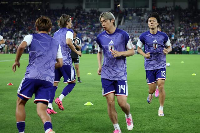 Japanese players warm up before the start of the 2026 World Cup Group F football match between Tunisia and Japan at the Monterrey Stadium in Guadalupe, Mexico, on June 20, 2026. (Photo by Julio Cesar AGUILAR / AFP)