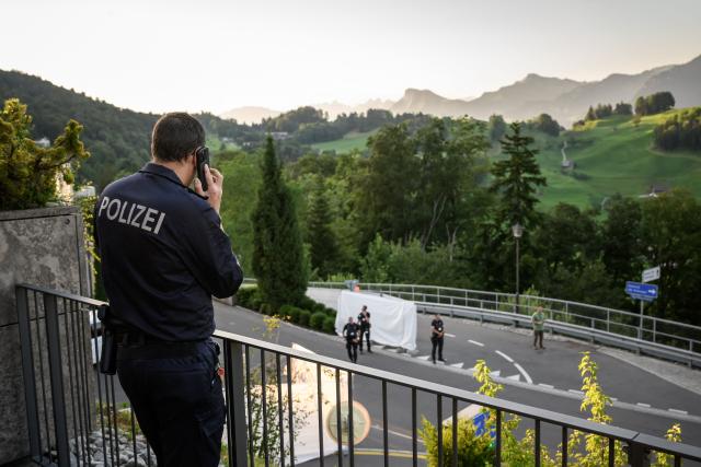 Police officers secure the Burgenstock luxury hotel complex overlooking Lake Lucerne, Switzerland, on June 21, 2026, ahead of high-level talks aimed at advancing a deal to end the Middle East conflict. A new round of negotiations over the Middle East war was set to kick off on June 21, 2026 with Iranian negotiators arriving in the Swiss host city hours ahead of US Vice President JD Vance, even as Tehran said it was closing the Strait of Hormuz again over Israeli attacks in Lebanon. (Photo by Fabrice COFFRINI / AFP)