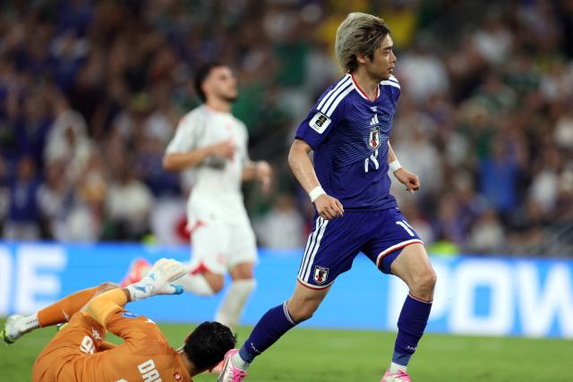 Japan's midfielder #14 Junya Ito watches the ball reaching the goal after beating Tunisia's goalkeeper #16 Aymen Dahmen to score his team third goal during the 2026 World Cup Group F football match between Tunisia and Japan at the Monterrey Stadium in Guadalupe, Mexico, on June 20, 2026.  (Photo by Julio Cesar AGUILAR / AFP)