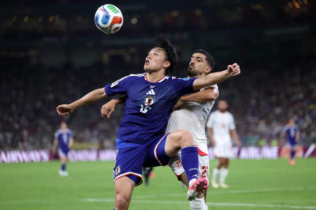 Japan's forward #18 Ayase Ueda and Tunisia's defender #21 Mohamed Ben Hamida fight for the ball during the 2026 World Cup Group F football match between Tunisia and Japan at the Monterrey Stadium in Guadalupe, Mexico, on June 20, 2026.  (Photo by Julio Cesar AGUILAR / AFP)