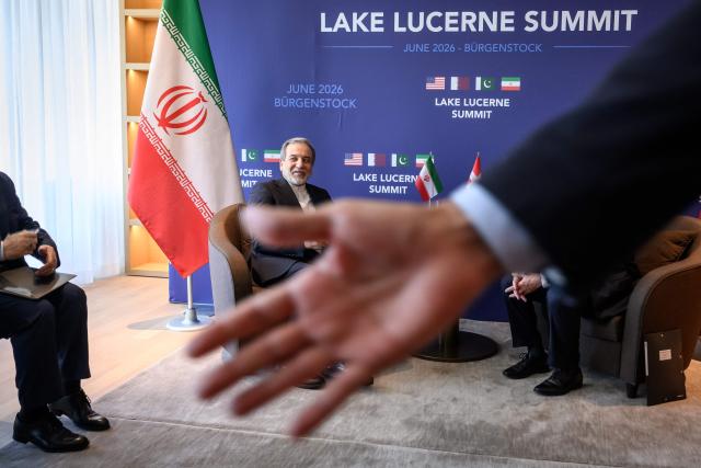 Iran's Foreign Minister Abbas Araghchi (L) looks on during a bilateral meeting with Switzerland's counterpart at the Burgenstock luxury hotel complex overlooking Lake Lucerne, Switzerland, on June 21, 2026, ahead of high-level talks aimed at advancing a deal to end the Middle East conflict. A new round of negotiations over the Middle East war was set to kick off on June 21, 2026 with Iranian negotiators arriving in the Swiss host city hours ahead of US Vice President JD Vance, even as Tehran said it was closing the Strait of Hormuz again over Israeli attacks in Lebanon. (Photo by Fabrice Coffrini / POOL / AFP)
