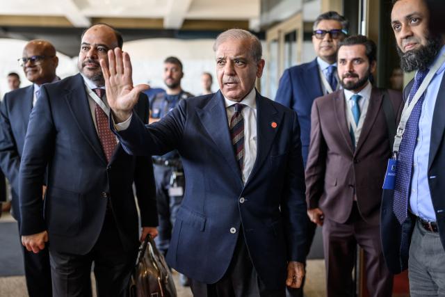 Pakistan's Prime Minister Muhammad Shehbaz Sharif gestures upon his arrival at the Burgenstock luxury hotel complex overlooking Lake Lucerne, Switzerland, on June 21, 2026, ahead of high-level talks aimed at advancing a deal to end the Middle East conflict. A new round of negotiations over the Middle East war was set to kick off on June 21, 2026 with Iranian negotiators arriving in the Swiss host city hours ahead of US Vice President JD Vance, even as Tehran said it was closing the Strait of Hormuz again over Israeli attacks in Lebanon. (Photo by Fabrice Coffrini / POOL / AFP)