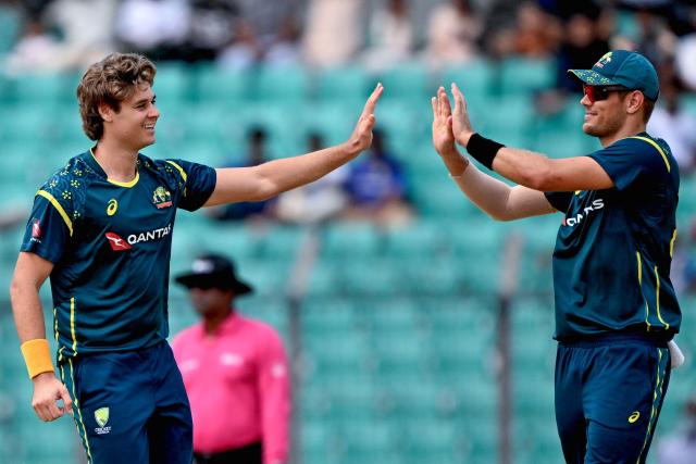 Australia's Spencer Johnson (L) celebrates with teammate after taking the wicket of Bangladesh's Saif Hassan during the third Twenty20 (T20) international cricket match between Bangladesh and Australia at the Bir Sreshtho Flight Lieutenant Matiur Rahman Stadium in Chattogram on June 21, 2026. (Photo by AFP)
