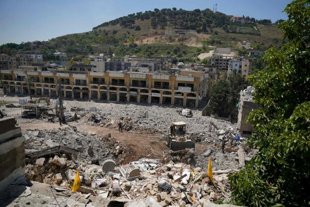 A bulldozer removes the rubble from the main market place destroyed by the Israeli military in the southern city of Nabatieh on June 21, 2026. The first round of negotiations between the United States and Iran since the two sides signed a preliminary agreement to halt their war was due to begin in Switzerland on June 21, with the conflict in Lebanon threatening the deal. Lebanon was drawn into the Middle East war on March 2 when Tehran-backed militant group Hezbollah launched attacks on Israel to avenge the killing of the Iranian leader. Israel has responded with broad strikes across Lebanon and a ground offensive. (Photo by Abbas FAKIH / AFP) / 