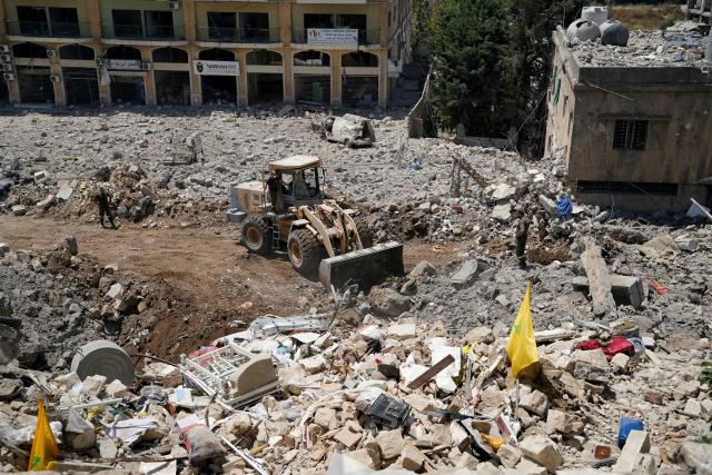 A bulldozer removes the rubble from the main market place destroyed by the Israeli military in the southern city of Nabatieh on June 21, 2026. The first round of negotiations between the United States and Iran since the two sides signed a preliminary agreement to halt their war was due to begin in Switzerland on June 21, with the conflict in Lebanon threatening the deal. Lebanon was drawn into the Middle East war on March 2 when Tehran-backed militant group Hezbollah launched attacks on Israel to avenge the killing of the Iranian leader. Israel has responded with broad strikes across Lebanon and a ground offensive. (Photo by Abbas FAKIH / AFP) / 