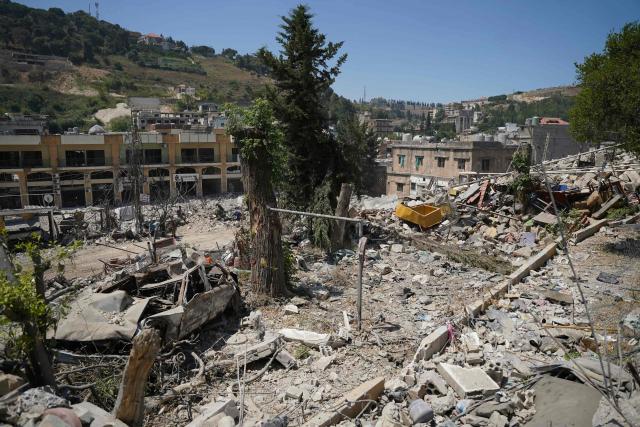 A destroyed vehicle sits amongst the rubble of the main market place destroyed by the Israeli military in the southern city of Nabatieh on June 21, 2026. The first round of negotiations between the United States and Iran since the two sides signed a preliminary agreement to halt their war was due to begin in Switzerland on June 21, with the conflict in Lebanon threatening the deal. Lebanon was drawn into the Middle East war on March 2 when Tehran-backed militant group Hezbollah launched attacks on Israel to avenge the killing of the Iranian leader. Israel has responded with broad strikes across Lebanon and a ground offensive. (Photo by Abbas FAKIH / AFP) / 