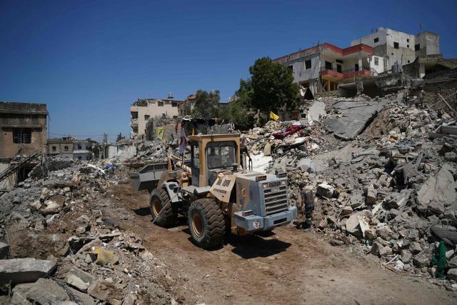 A bulldozer removes the rubble from destroyed businesses and home destroyed by the Israeli military in the southern city of Nabatieh on June 21, 2026. The first round of negotiations between the United States and Iran since the two sides signed a preliminary agreement to halt their war was due to begin in Switzerland on June 21, with the conflict in Lebanon threatening the deal. Lebanon was drawn into the Middle East war on March 2 when Tehran-backed militant group Hezbollah launched attacks on Israel to avenge the killing of the Iranian leader. Israel has responded with broad strikes across Lebanon and a ground offensive. (Photo by Abbas FAKIH / AFP) / 