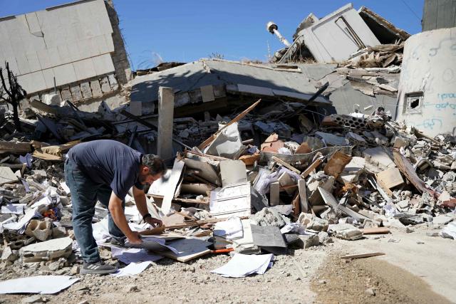 A man inspects the damage at the site of Lebanon's central bank building that was targeted in an Isreali strike the previous day in the southern Lebanese city of Nabatieh on June 21, 2026. (Photo by Abbas FAKIH / AFP) / 