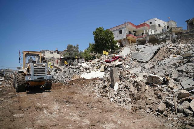 A bulldozer clears the rubble following at the site of Lebanon's central bank building that was targeted in an Isreali strike the previous day in the southern Lebanese city of Nabatieh on June 21, 2026. (Photo by Abbas FAKIH / AFP) / 
