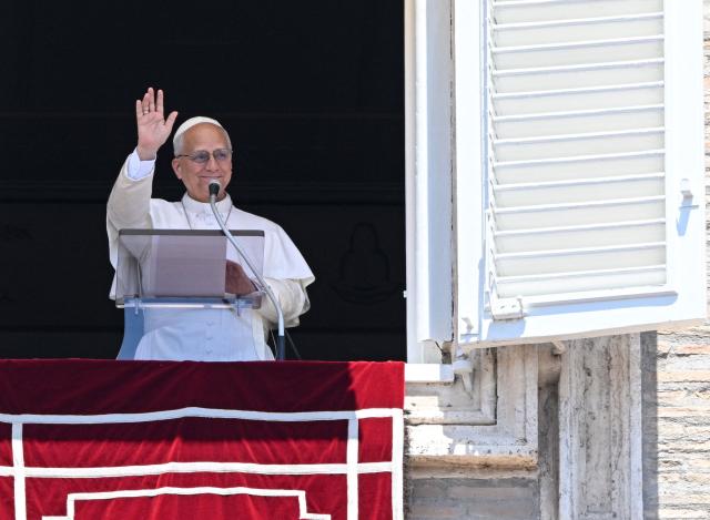 Pope Leo XIV blesses the crowd from a window of the apostolic palace overlooking St Peter's Square during the Angelus prayer in The Vatican on June 21, 2026. (Photo by TIZIANA FABI / AFP)