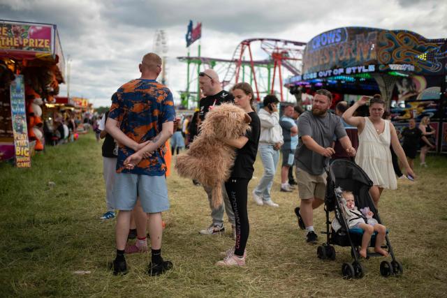 Members of the public attend The Hoppings fun fair, believed to be one of the largest travelling funfairs in Europe, in Newcastle upon Tyne, north east England on June 20, 2026. The fun fair, which originally began as a Temperance Fair in 1882, comprises of over 400 attractions set up on the city's Town Moor. The fair runs until June 28, 2026 and is expected to attract around 500,000 people. (Photo by Oli SCARFF / AFP)